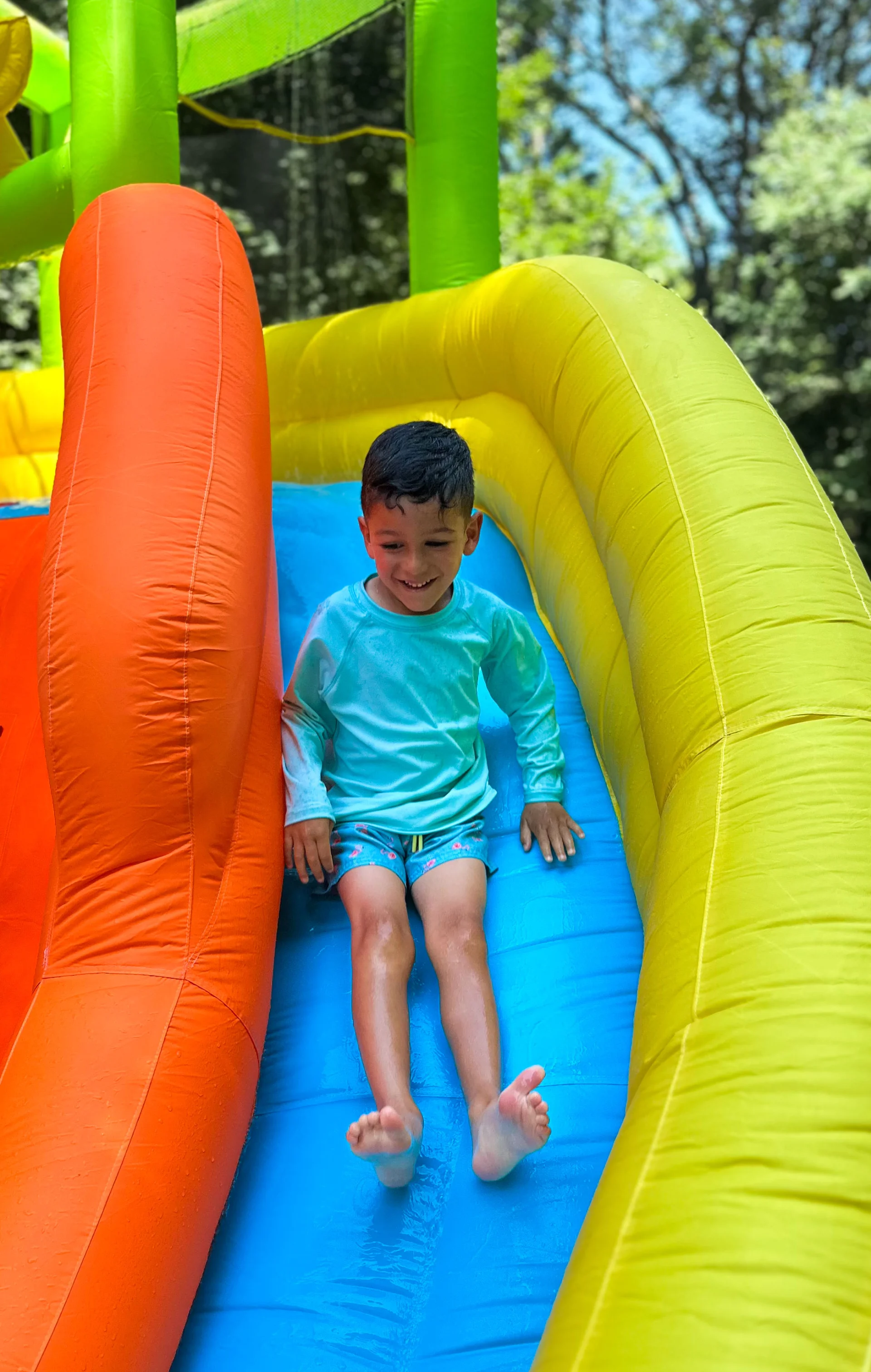 preschooler going down a slide in their summer camp
